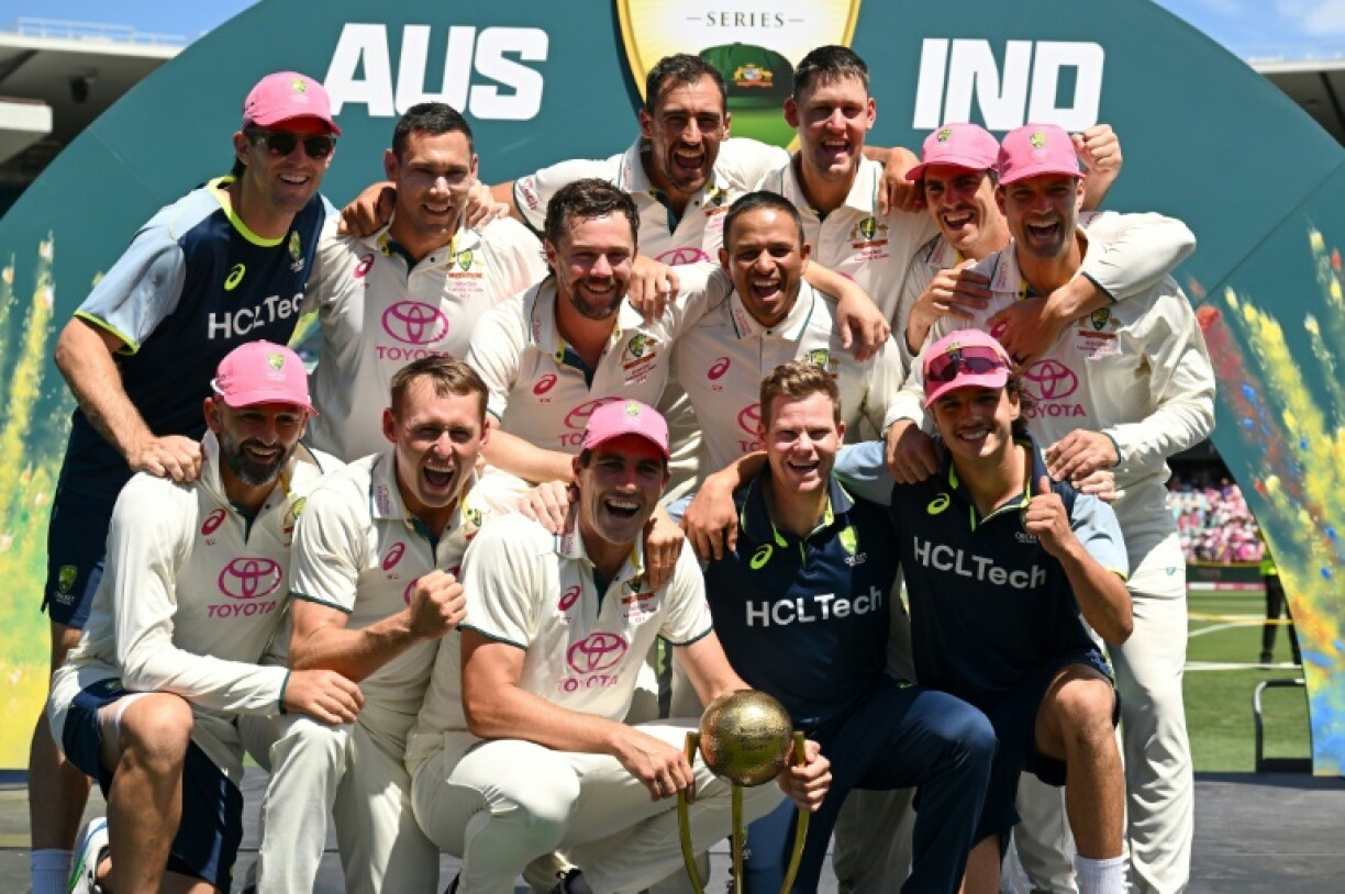 Australia players celebrate with the Border–Gavaskar Trophy after winning the fifth Test and the series 3-1 against India