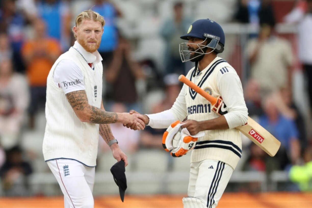 England captain Ben Stokes (L) shakes hands with India's Ravindra Jadeja (R) following a draw in the fourth Test at Old Trafford
