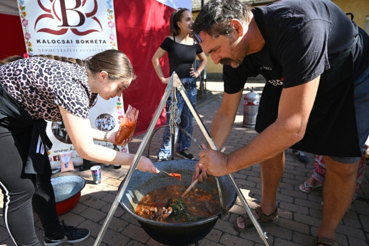 Teams competing in a cooking contests poured generous amounts of paprika into their cauldrons