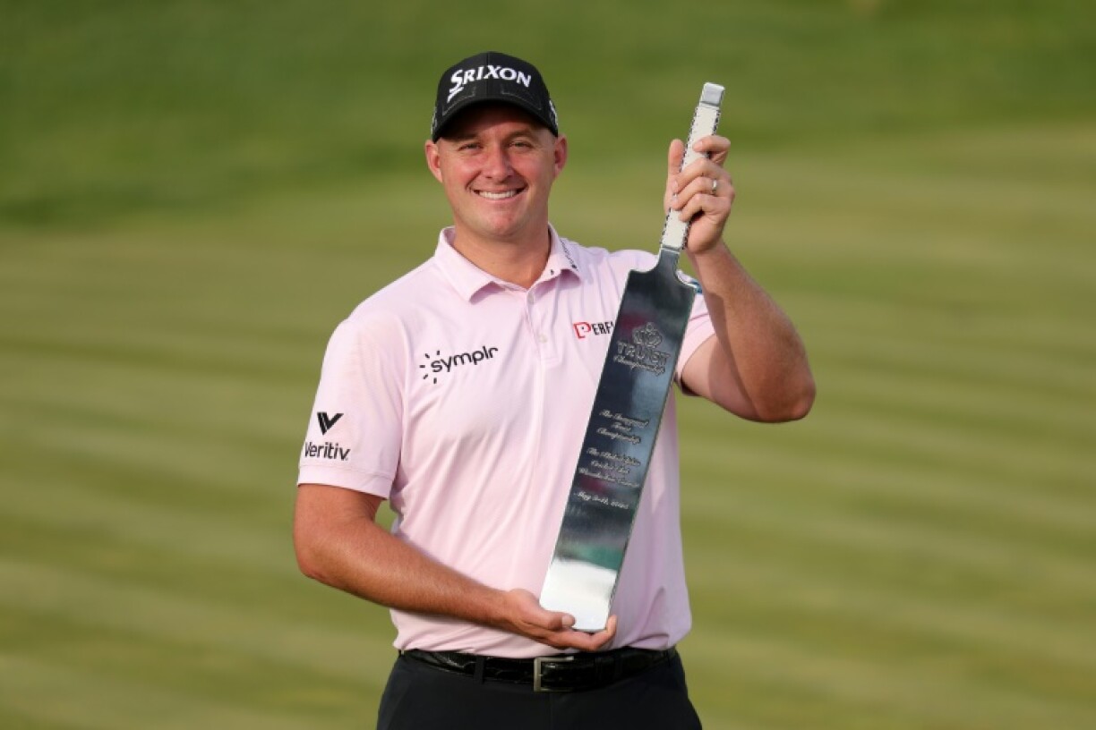 Sepp Straka poses with the cricket bat trophy after winning the Truist Championship at The Philadelphia Cricket Club on Sunday.