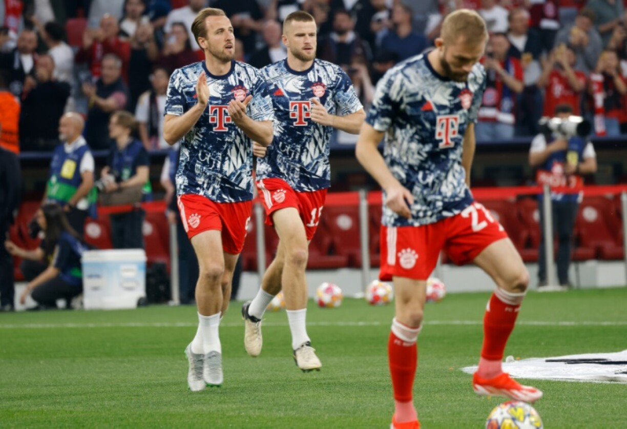 Harry Kane (L) and Eric Dier (C) warm up together ahead of a Champions League match in April 2024