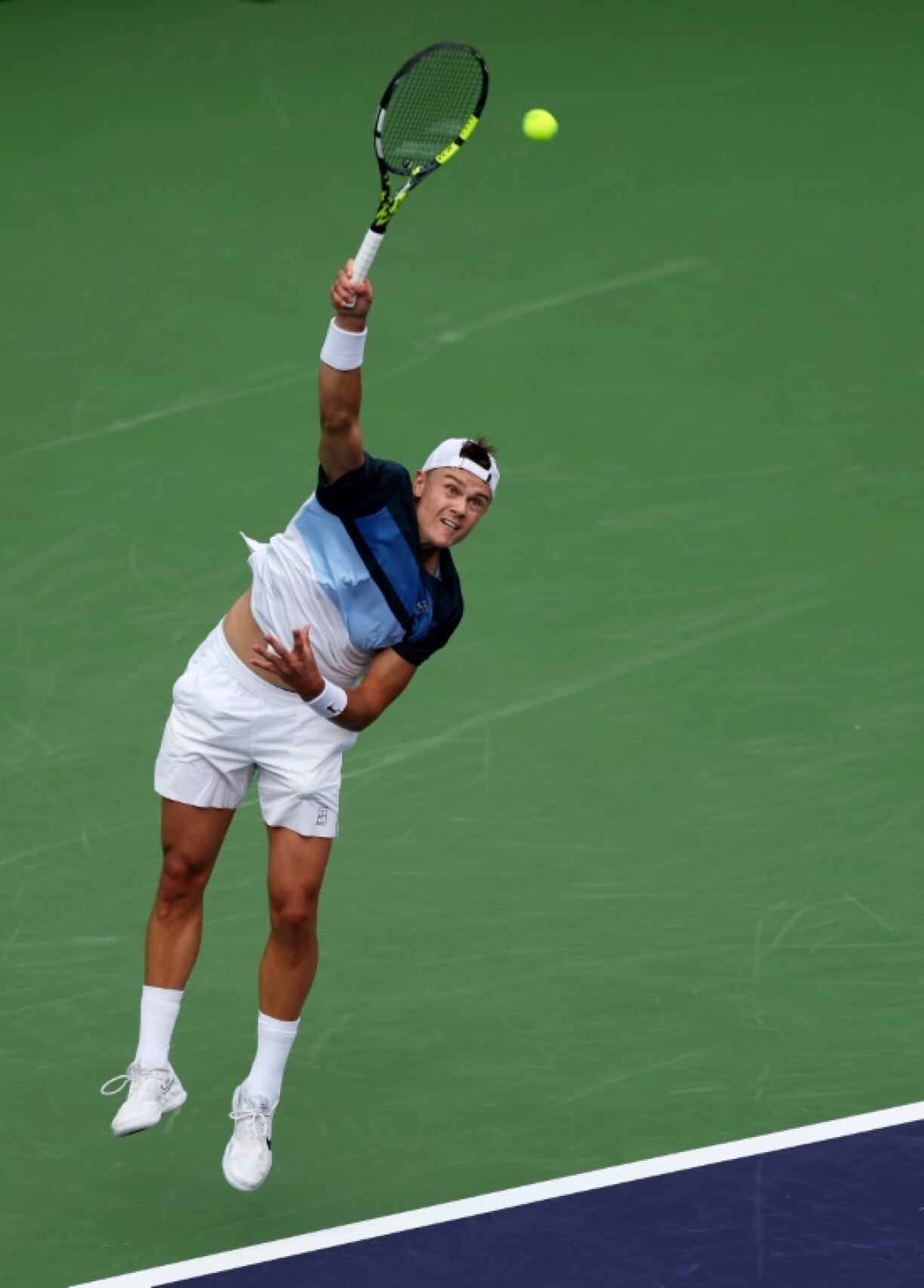 Denmark's Holger Rune unleashes a serve en route to victory over Stefanos Tsitsipas