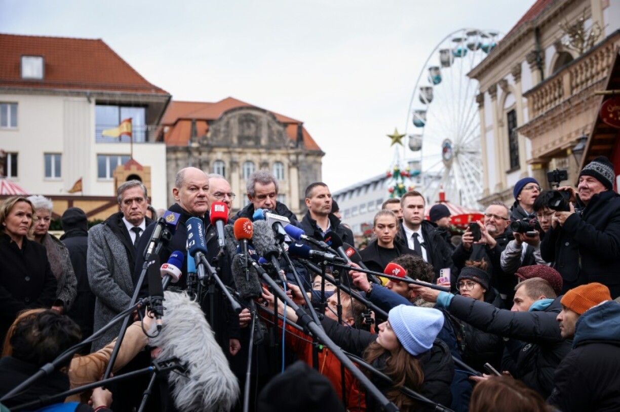 Chancellor Olaf Scholz led a group of black-clad ministers who condemned the violence and laid flowers to pay their respects and offer condolences