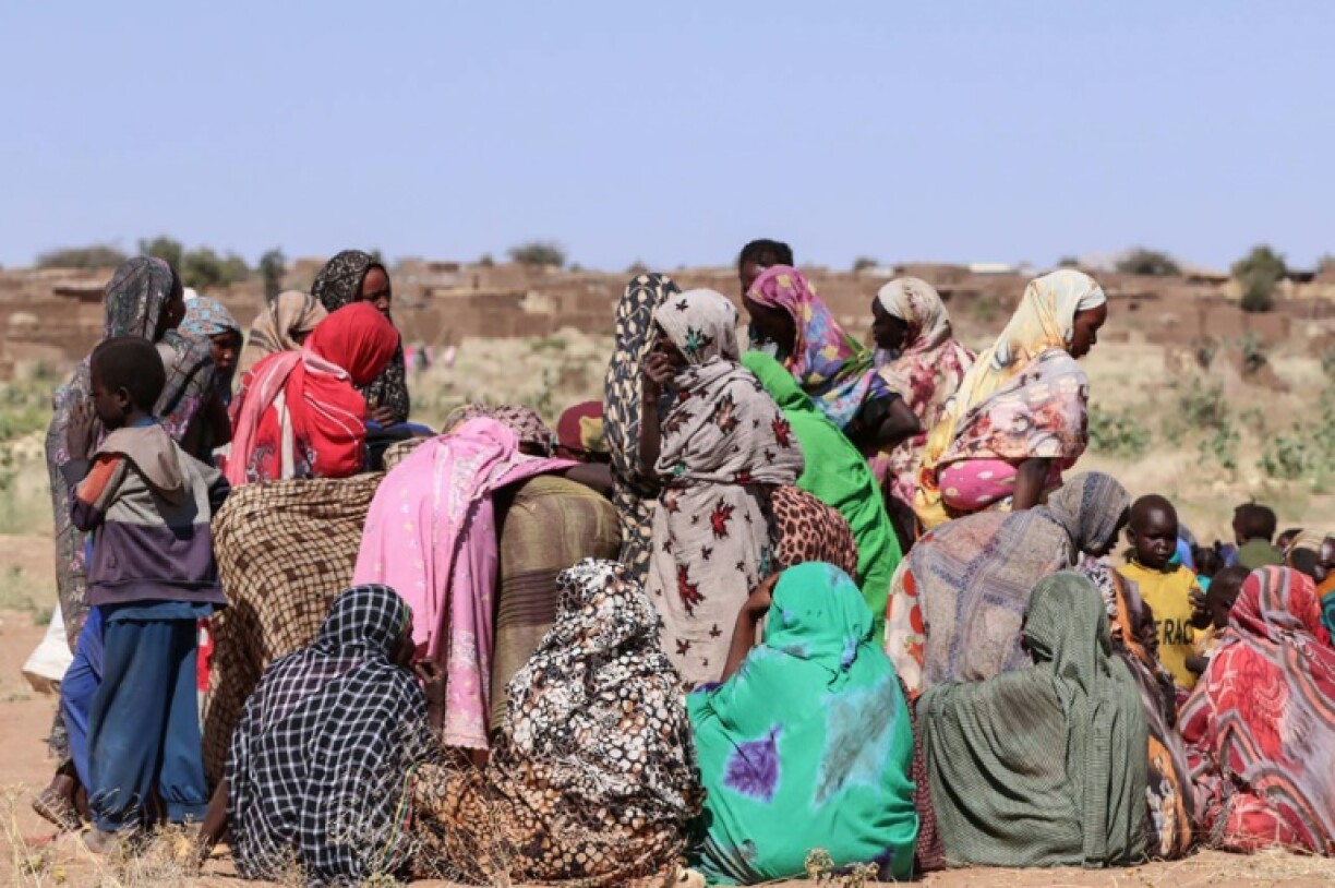 Displaced Sudanese women and children gather at a camp near the town of Tawila in North Darfur on February 11, 2025
