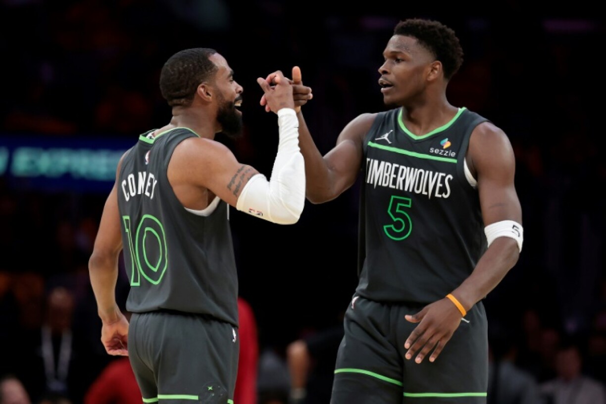 Mike Conley and Anthony Edwards of the Minnesota Timberwolves celebrate a play in the Timberwolves' victory over the Los Angeles Lakers in game one of their NBA Western Conference playoff series