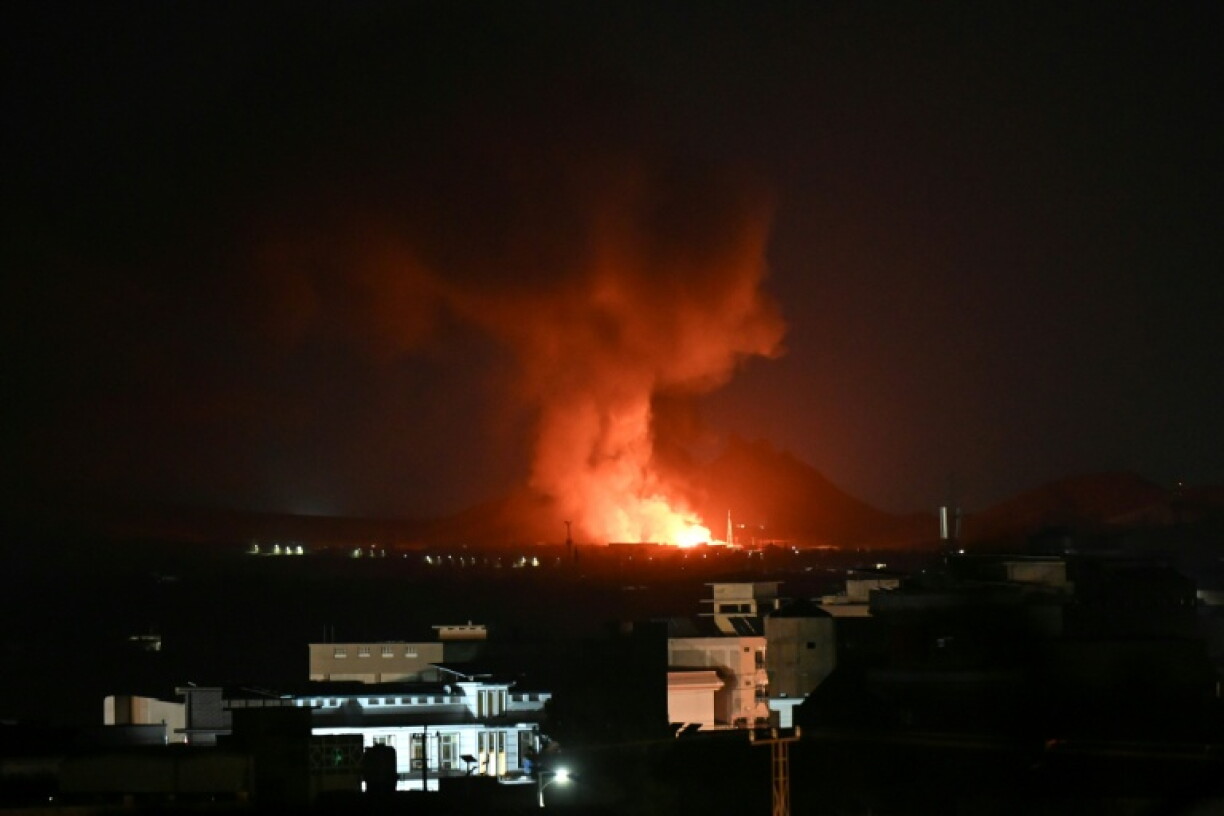 Flames and smoke rise from an area struck by an airstrike in Kandahar on Thursday