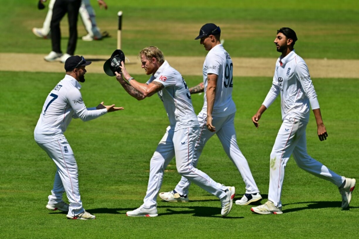 England captain Ben Stokes (2L) celebrates with team-mates after running out India's Rishabh Pant in the third Test at Lord's
