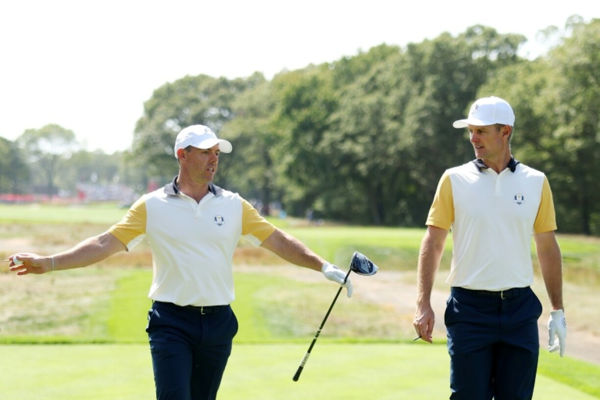 Justin Rose (R) knows team-mate Rory McIlroy could be in for a rough ride from US fans at the Ryder Cup
