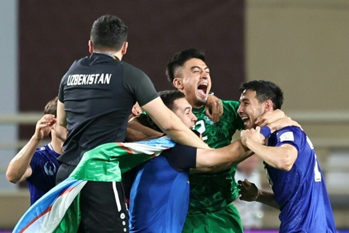 Uzbekistan's players celebrate after qualifying for the World Cup for the first time