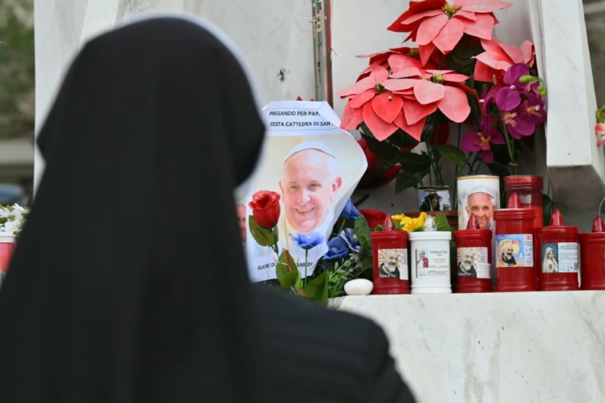 A nun prays for Pope Francis outside Rome's Gemelli hospital