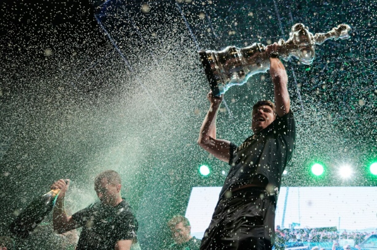 Peter Burling raises the America's Cup trophy after Emirates Team New Zealand's succesful defence in 2024