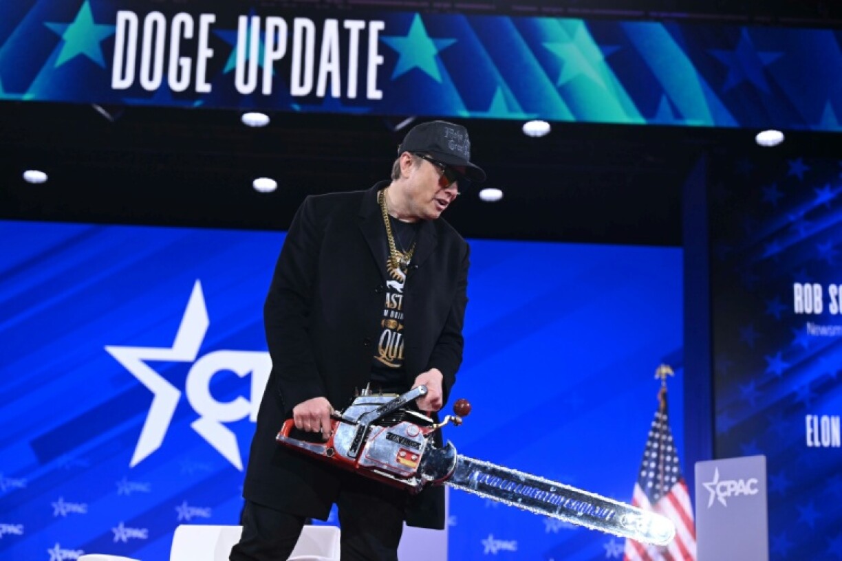 Elon Musk, former the head of the Department of Government Efficiency (DOGE), holds a chainsaw, a symbol of cost-cutting, as he speaks at the annual Conservative Political Action Conference in February 2025
