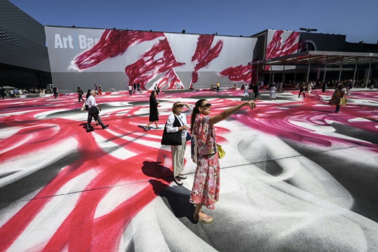 Visitors walk on the artwork 'Choir' by the German artist Katharina Grosse at the Art Basel fair entrance