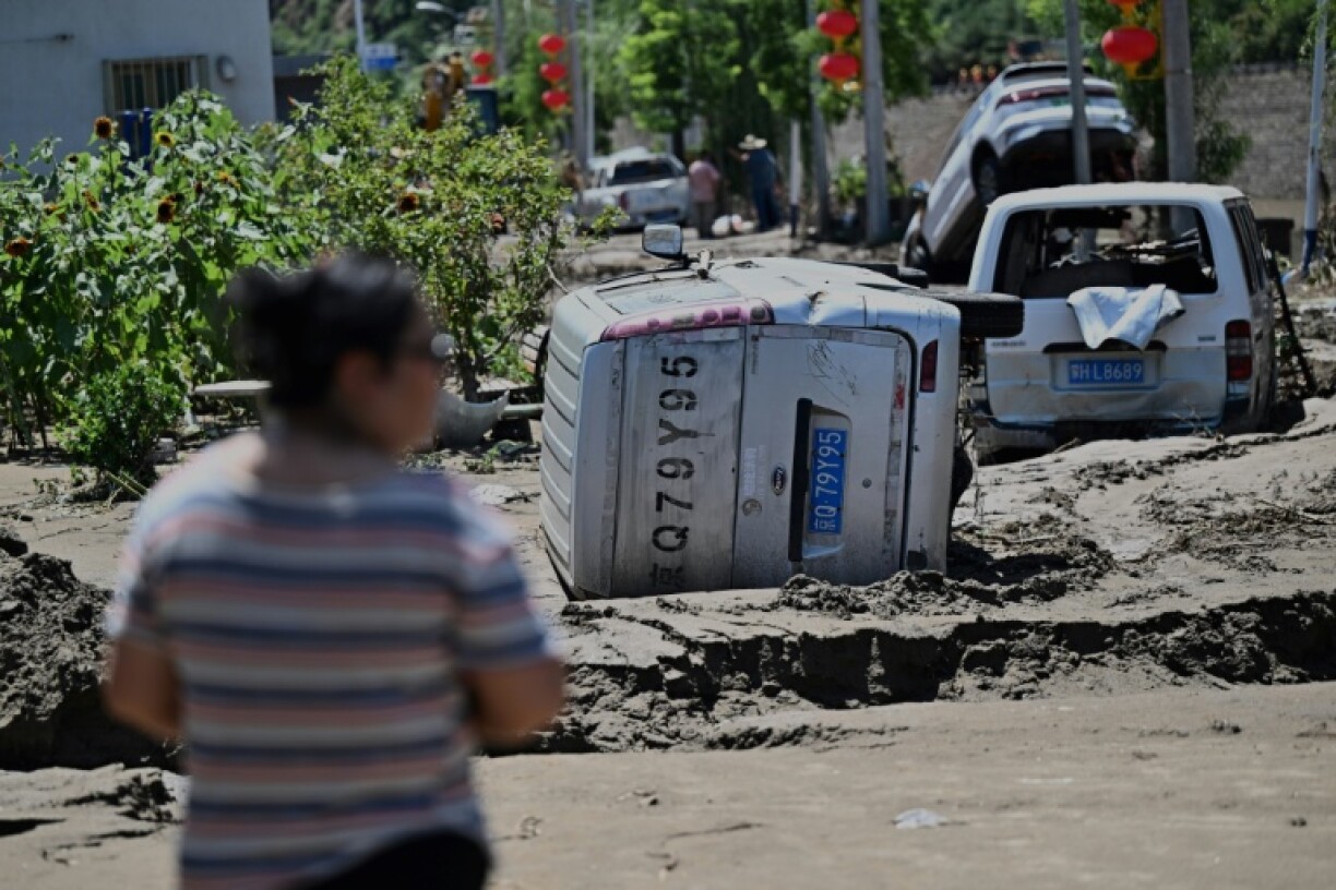 Damaged cars seen at the end of July in Huairou district, on the outskirts of Beijing after heavy rains caused widespread flooding
