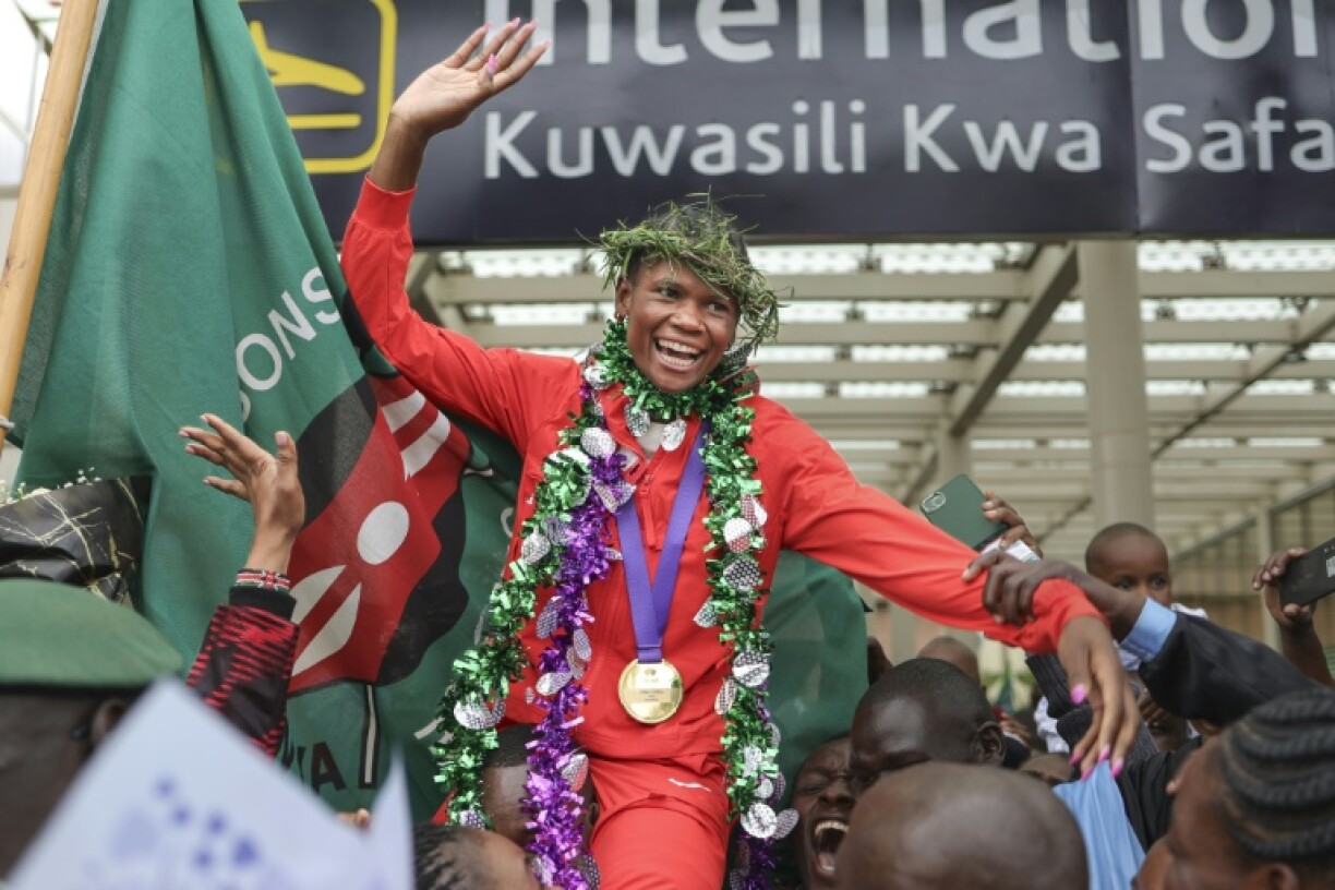 Kenya's Lilian Odira is hoisted shoulder high upon her return home after winning women's 800m gold at the world championships in Tokyo