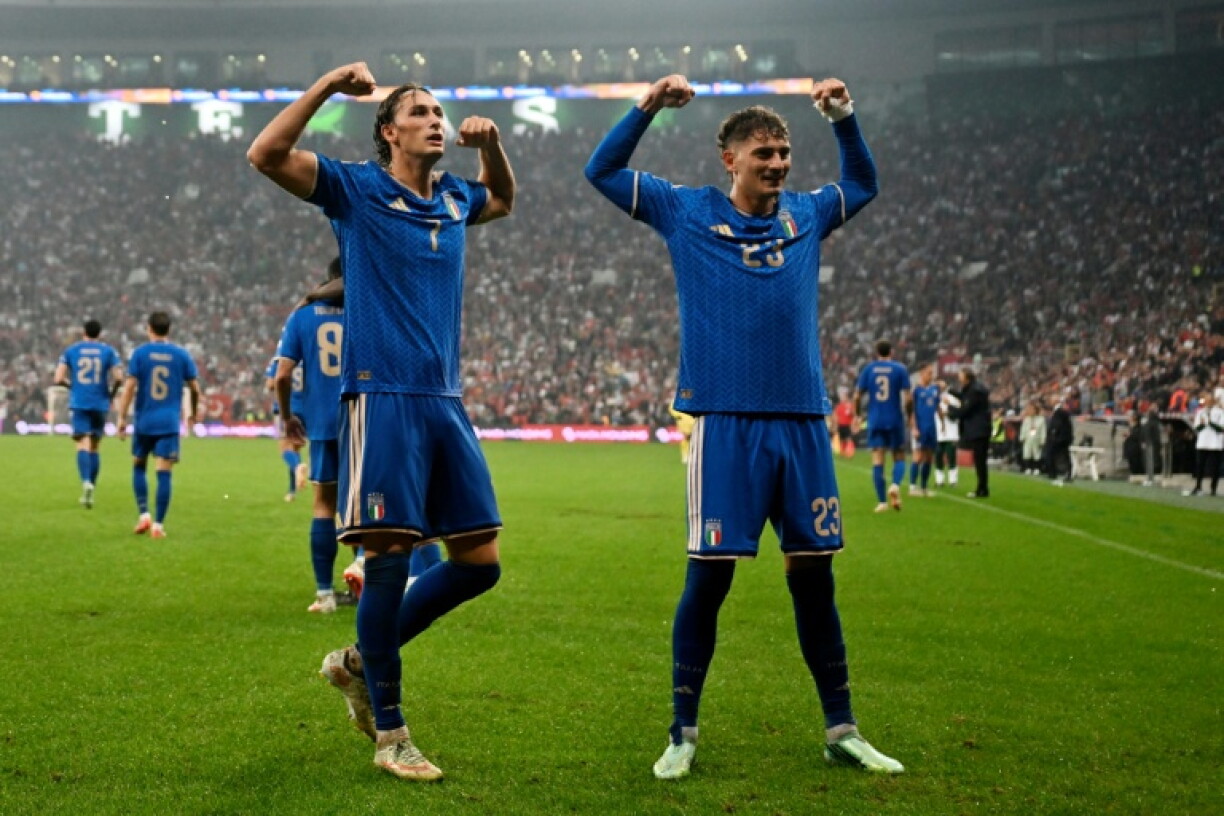 Pio Esposito (left) celebrates scoring Italy's fourth goal with Gianluca Mancini in Bursa
