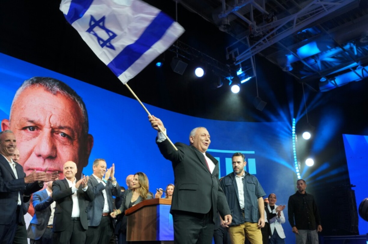 Opposition candidate Gadi Eisenkot waves Israel's national flag at an election night rally in Tel Aviv