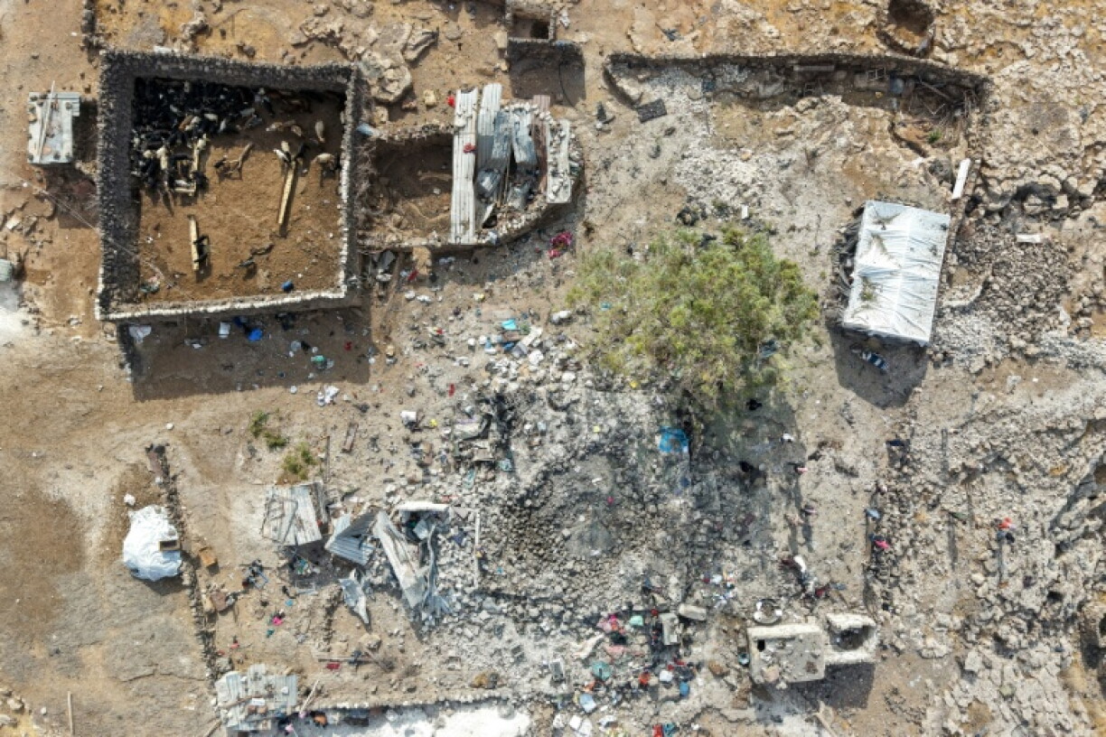 People inspecting the damage at a site targeted by airstrikes