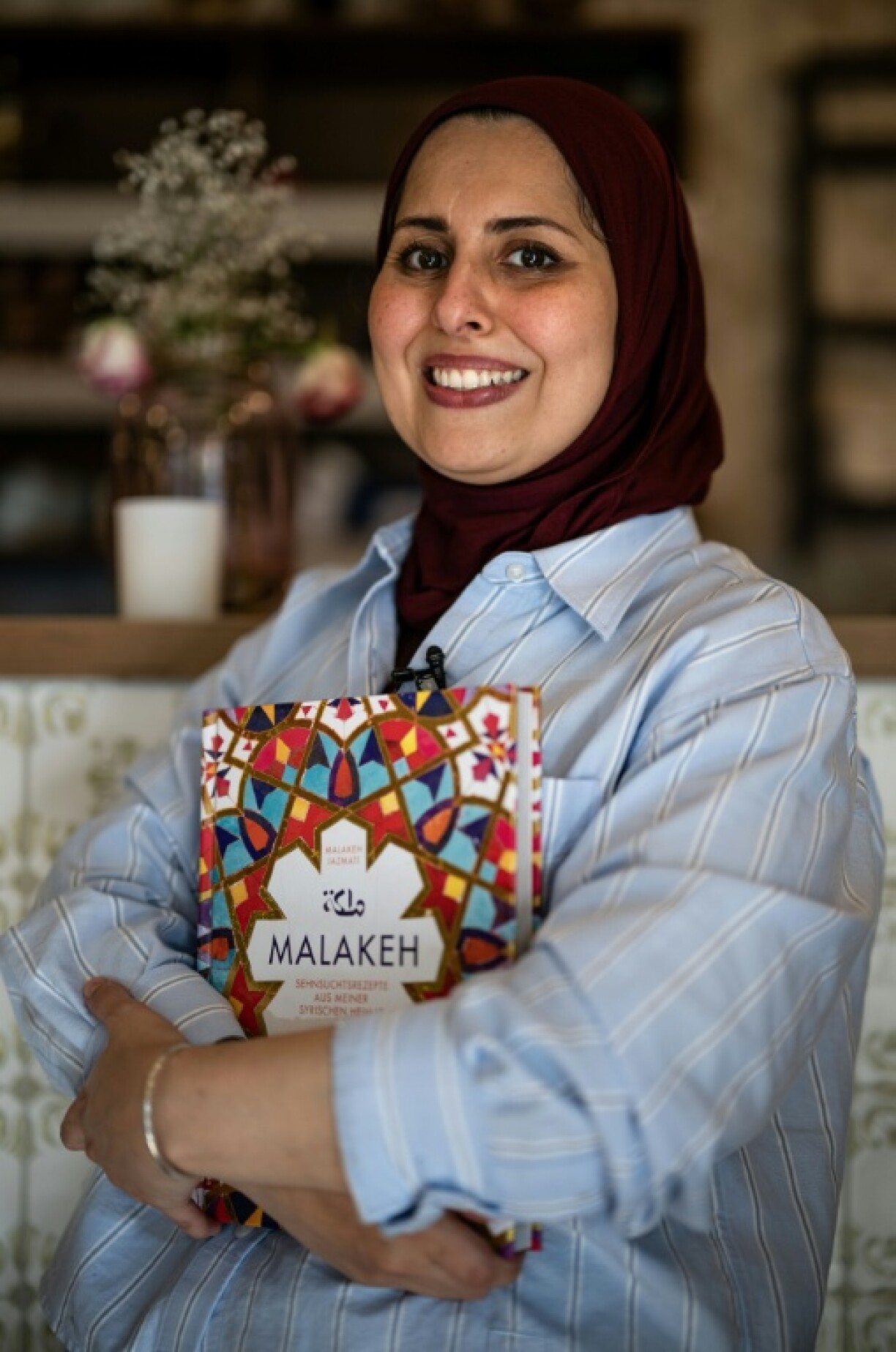 Success story: Syrian Malakeh Jazmati in her Berlin restaurant with her cookbook