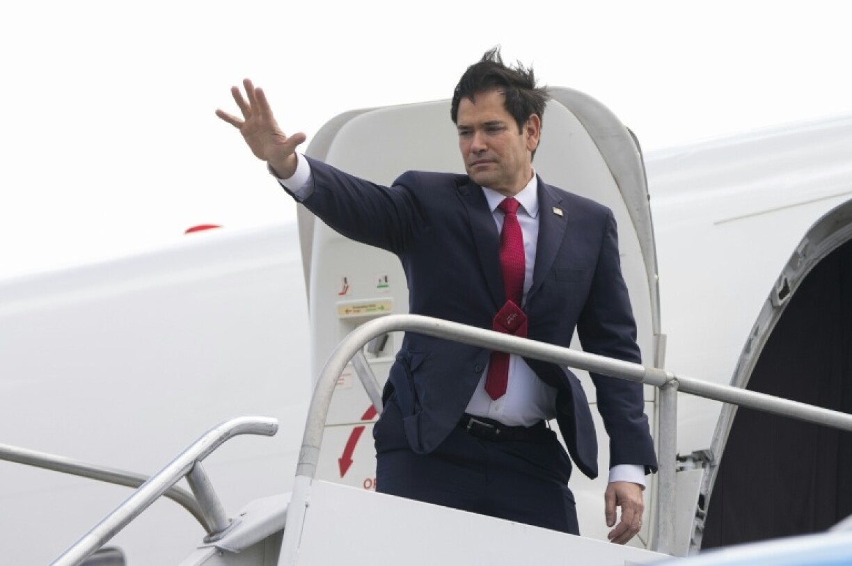 US Secretary of State Marco Rubio waves as he boards a plane bound to Guatemala at Juan Santamaria International Airport near San Jose, Costa Rica on February 4, 2025.