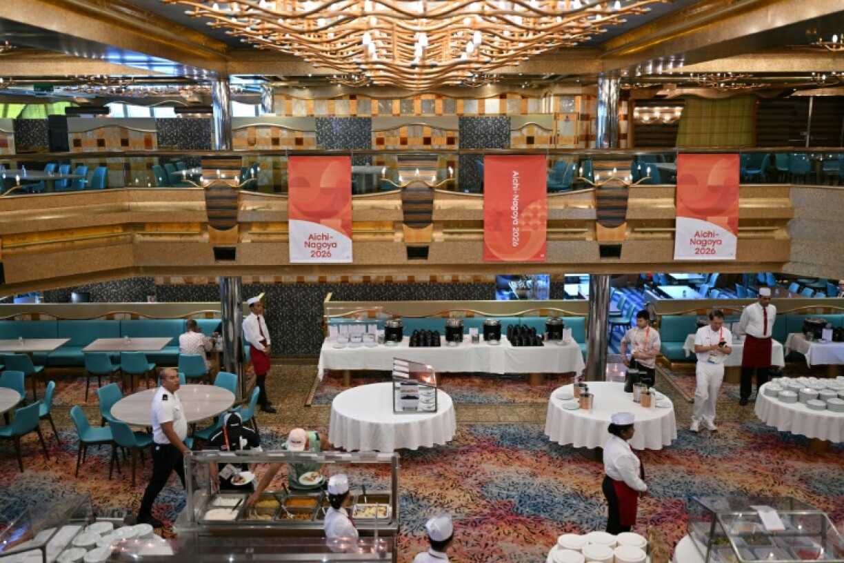 Attendants look on in the dining room on the Costa Serena