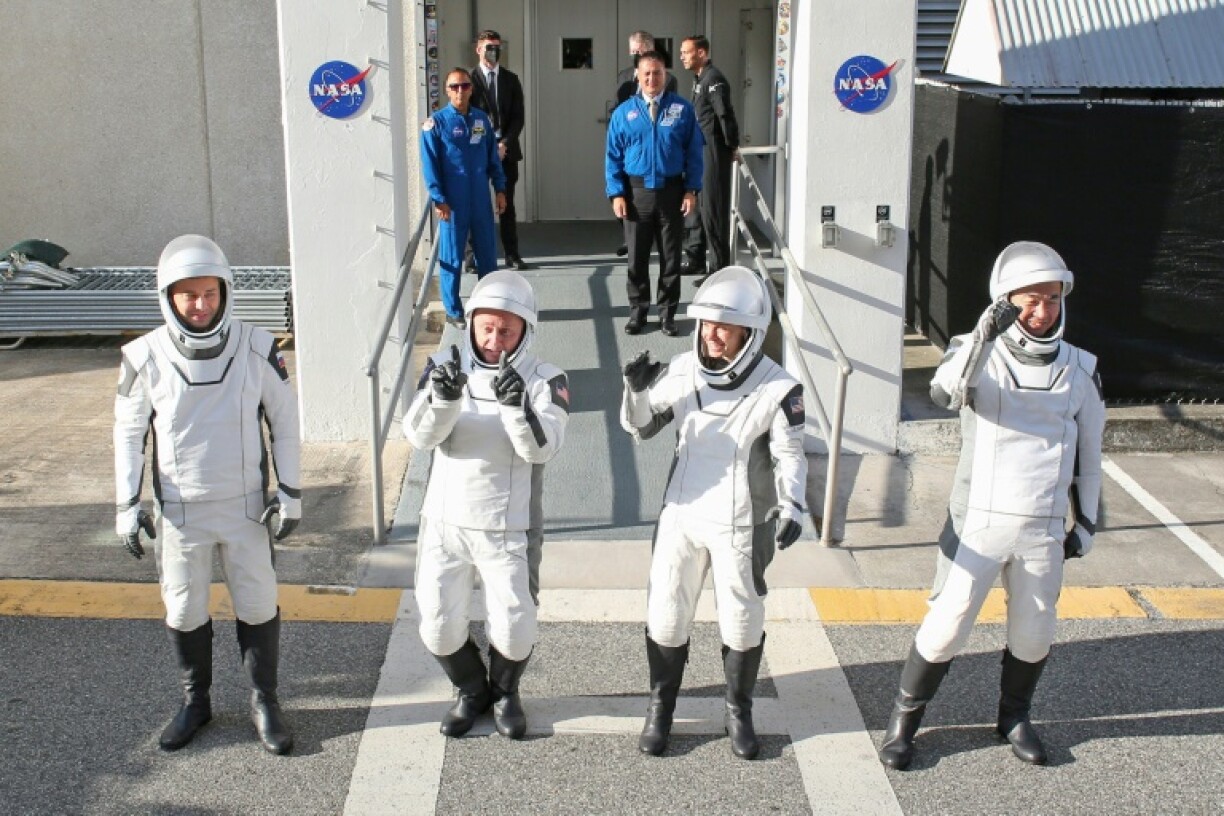 Crew-11 mission astronauts pause outside the Neil A. Armstrong Operations and Checkout Building en route to launch complex LC-39A at the Kennedy Space Center in Cape Canaveral, Florida on August 1, 2025