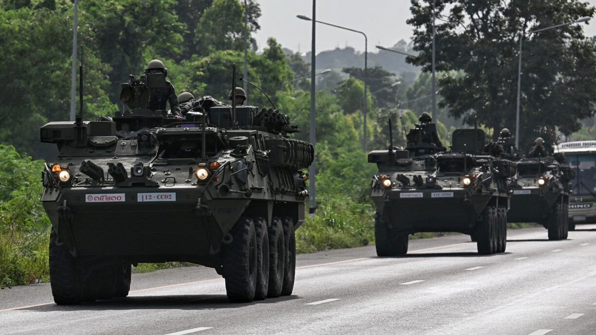 Royal Thai Army soldiers are pictured on armoured vehicles on a road in Chachoengsao province on 24 July 2025.