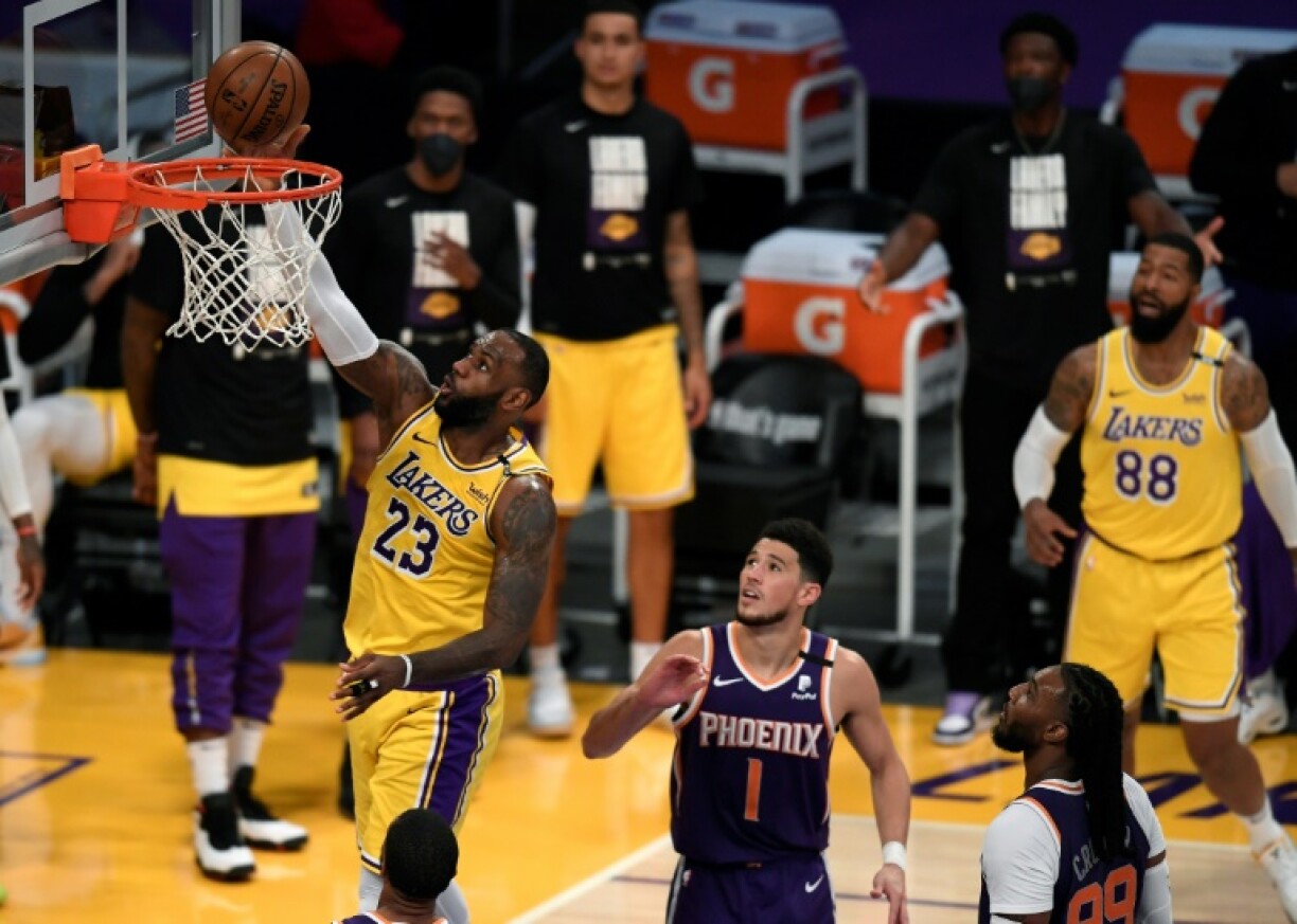LeBron James (Los Angeles Lakers) marque un panier sous le regard de Devin Booker (Phoenix Suns), lors de leur 6e match du 1er tour des playoffs NBA, le 3 juin 2021 au Staples Center à Los Angeles