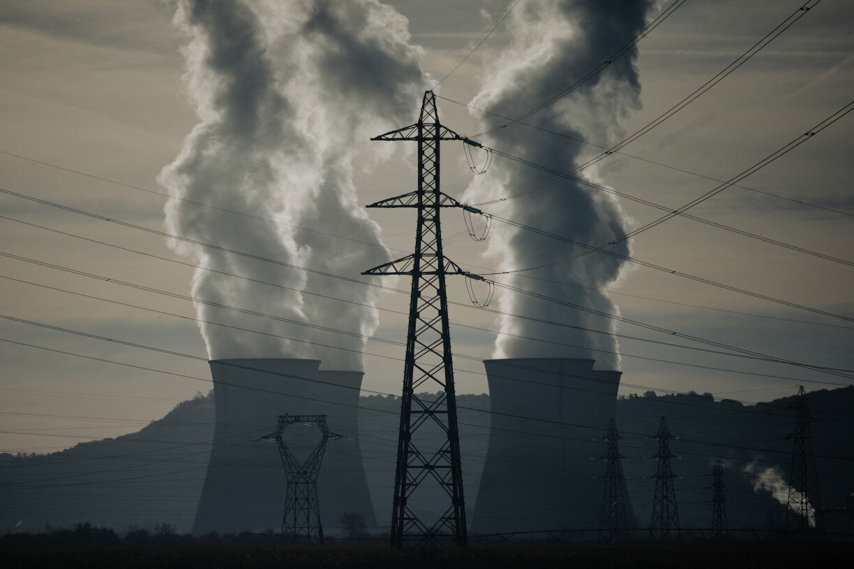This photo shows high-voltage power line towers and water vapor rising from the Bugey nuclear power plant, in Saint-Vulbas on September 25, 2026. (Photo by Alex MARTIN / AFP)