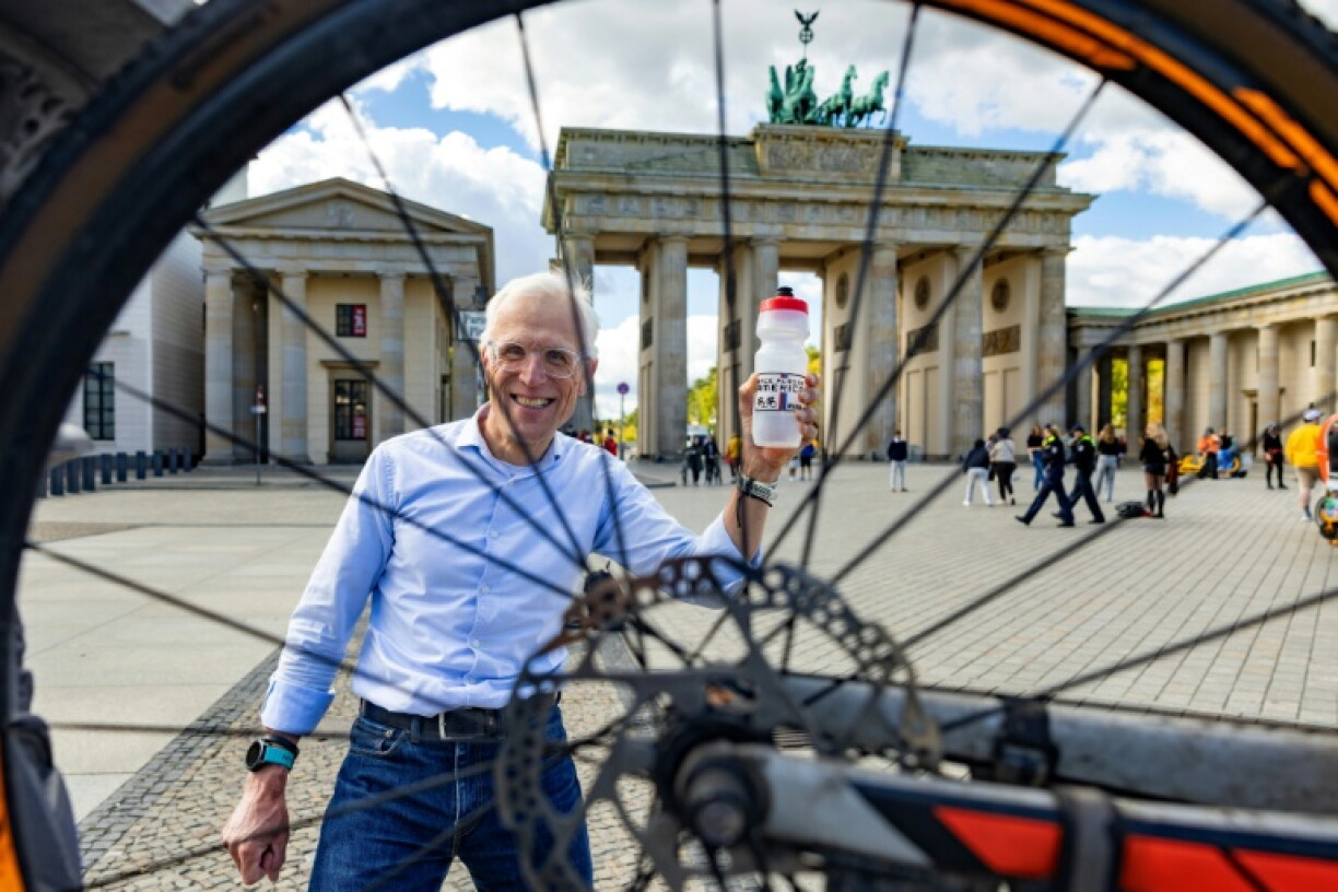 Claus-Henning Schulke, known as 'Bottle Claus', is seen through the spokes of his bicycle in Berlin.