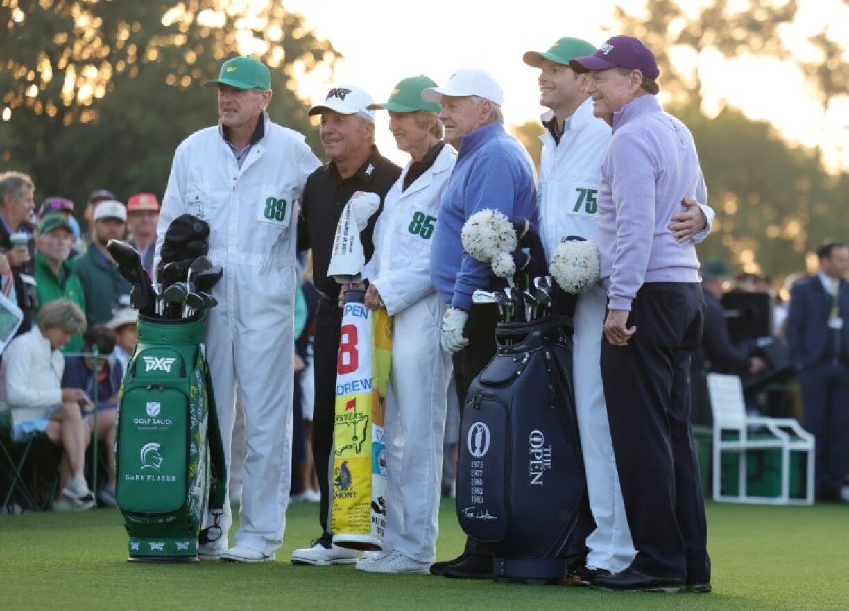 Honorary Starters Gary Player of South Africa and Americans Jack Nicklaus and Tom Watson of the United States pose with their caddies on the first tee after hitting honorary tee shots to start the 89th Masters