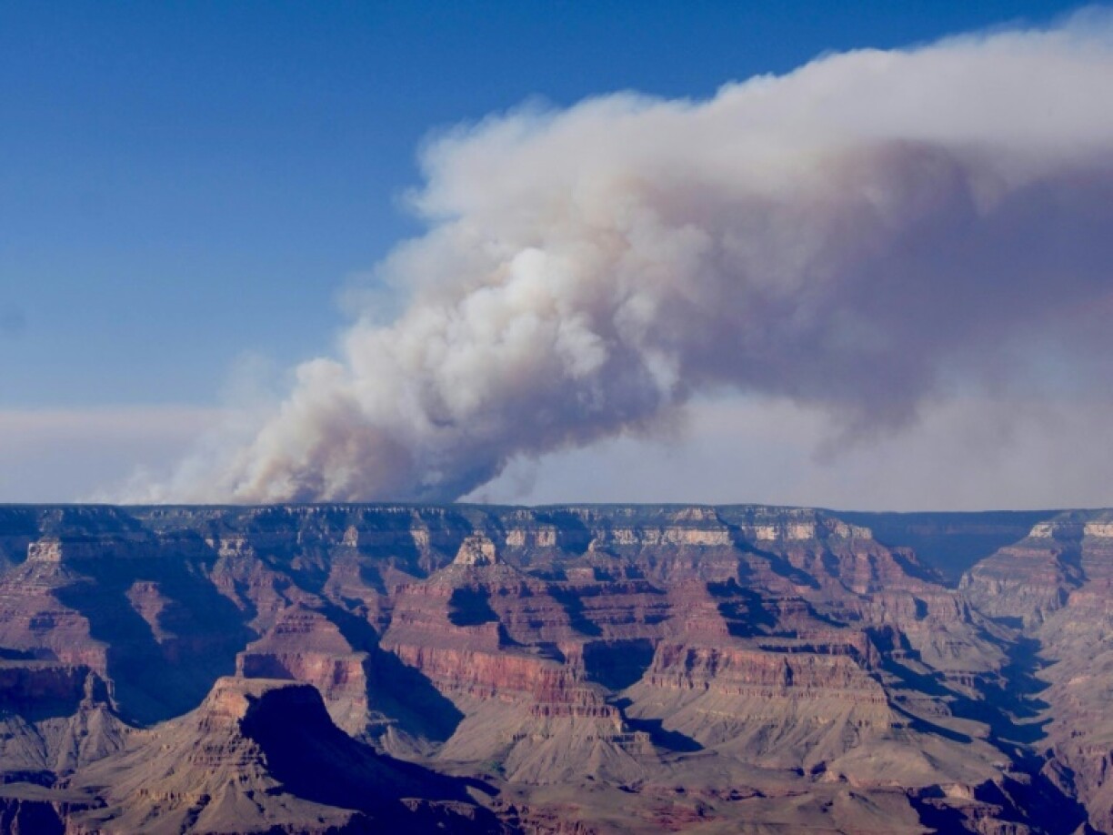 A huge column of smoke rises from the Grand Canyon