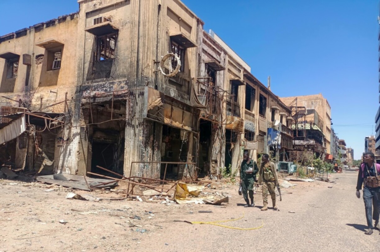 Fighters loyal to the army patrol a market area in Khartoum