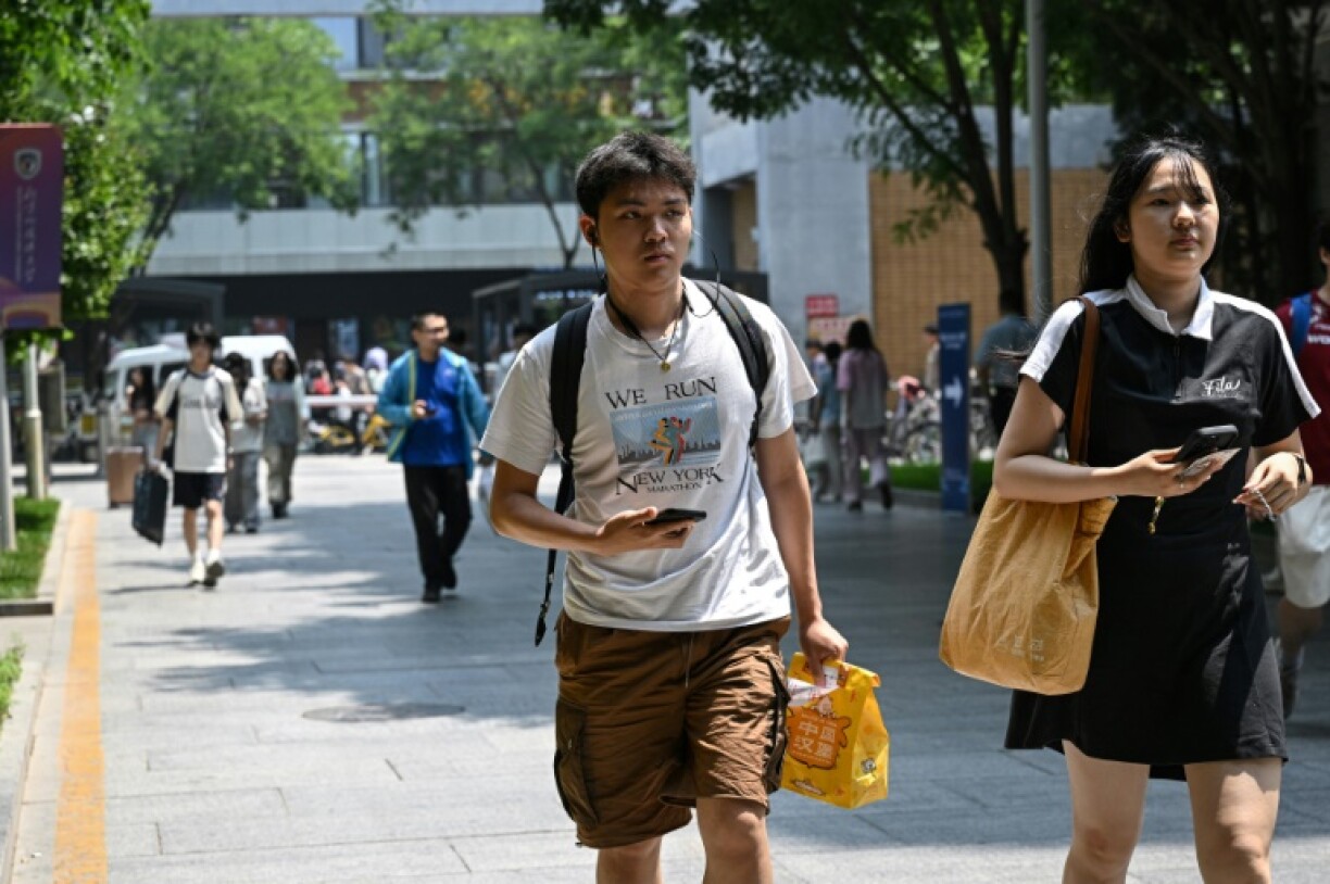A Chinese student wearing a New York marathon t-shirt walks at Beijing Foreign Studies University