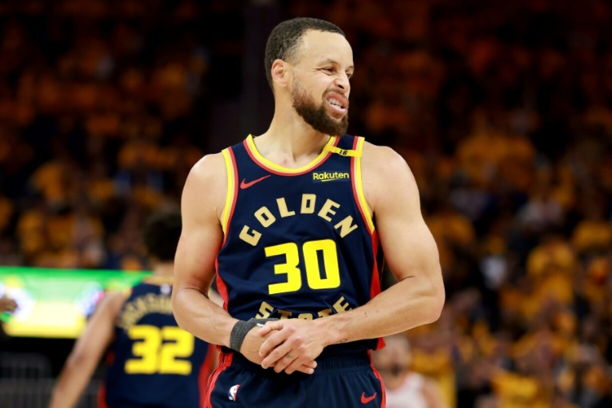 Golden State Warriors Stephen Curry holds his injured thumb during game four of the team's NBA playoff series against the Houston Rockets