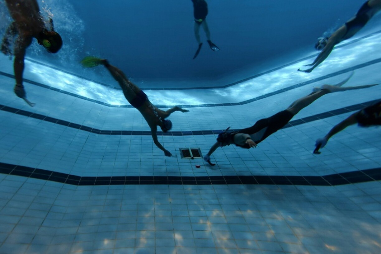 Underwater hockey players take part in the 2026 HKUWHA Under Water Hockey tournament in Hong Kong on October 17, 2026. The annual underwater hockey tournament, ominously advertised as "physical hell", nevertheless drew a roster of hardcore enthusiasts from countries across Asia.