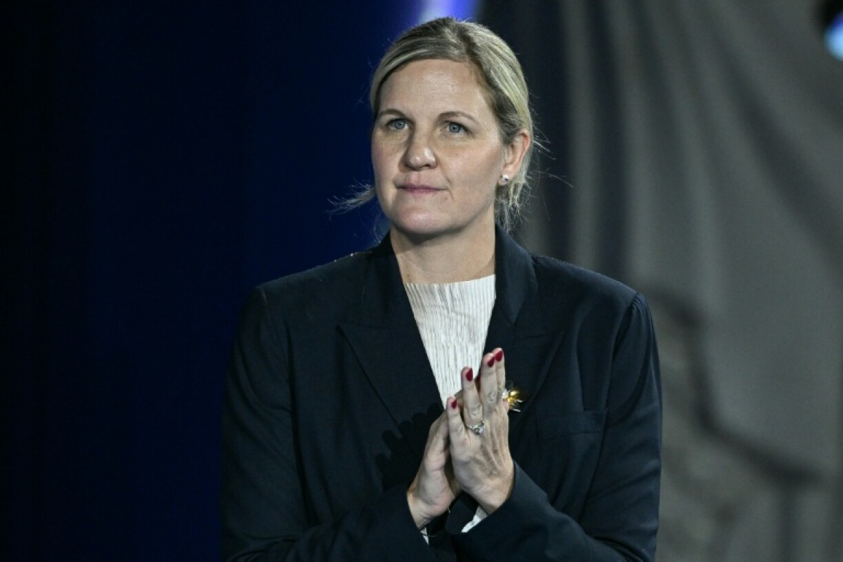 The President of the International Olympic Committee Kirsty Coventry reacts on the podium of the women's 100m backstroke swimming event during the 2025 World Aquatics Championships in Singapore