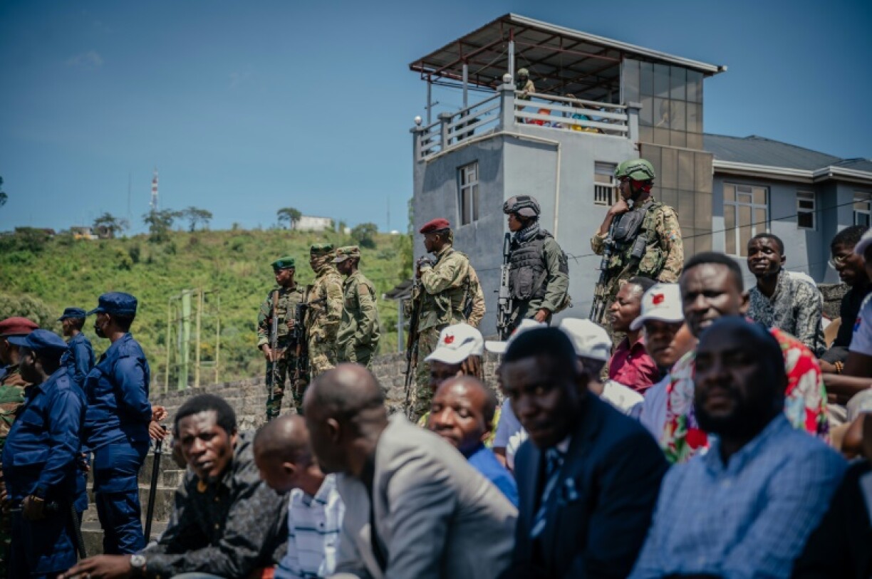 M23 fighters stand guard during a service organized by the rebels' administration at a stadium in Goma on May 18, 2025