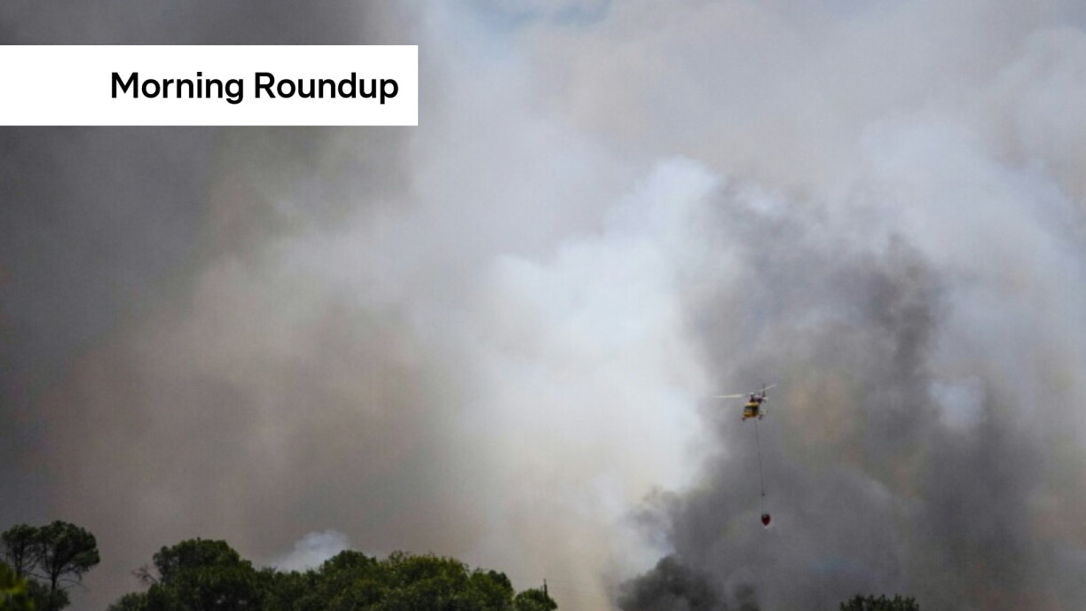 A helicopter flies over a wildfire burning near La Bisbal de l'Empordà in northeastern Spain on 3 July 2026. The fire has since been brought under control.