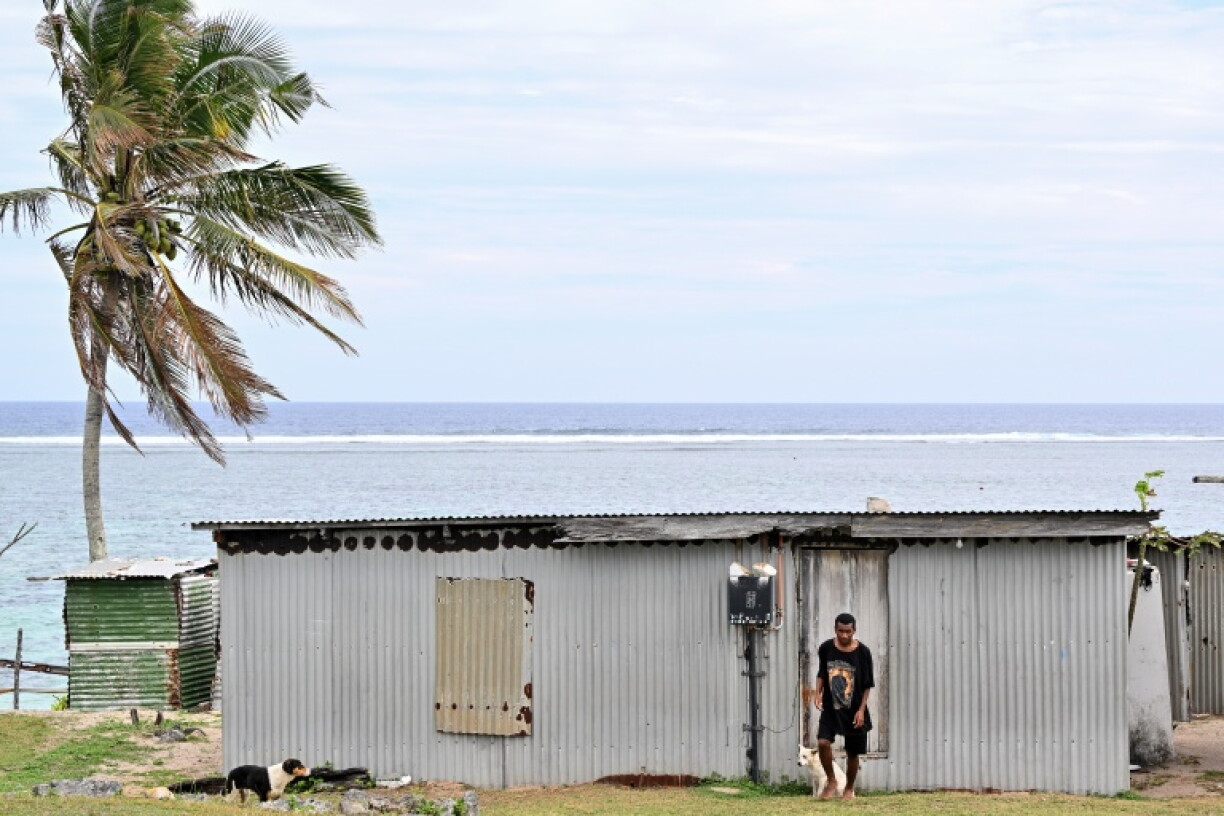 A villager leaves his house in the Naidiri Marine Biodiversity Park, a marine protected area about 52 kilometres from Nadi