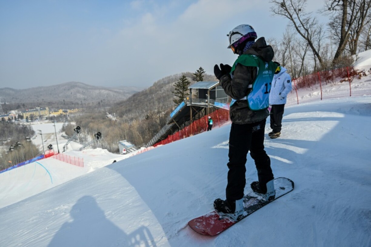 Afghanistan's Ahmad Habibzi prays before a snowboard halfpipe run