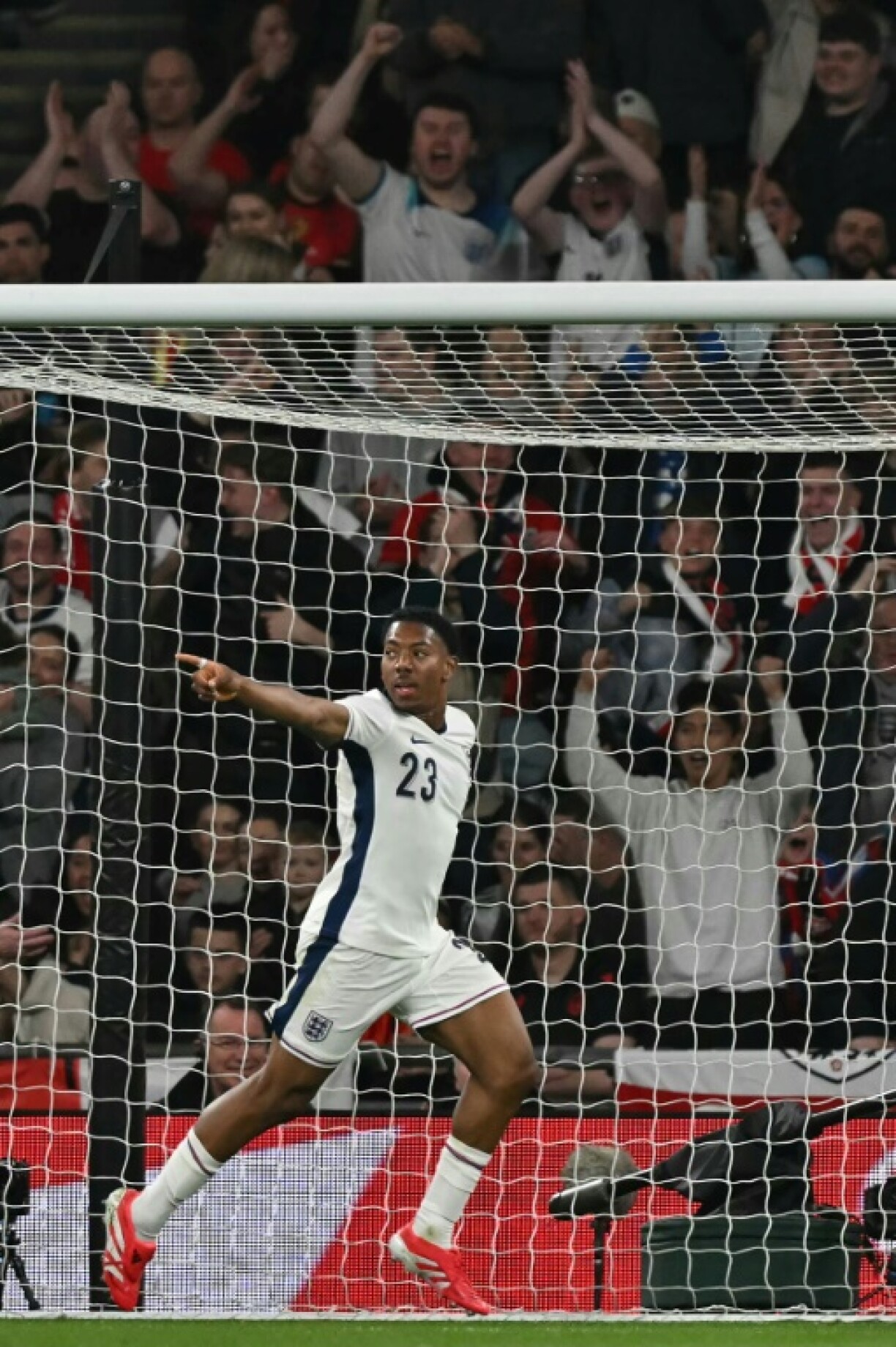 Off the mark: Myles Lewis-Skelly celebrates after scoring the opening goal for England