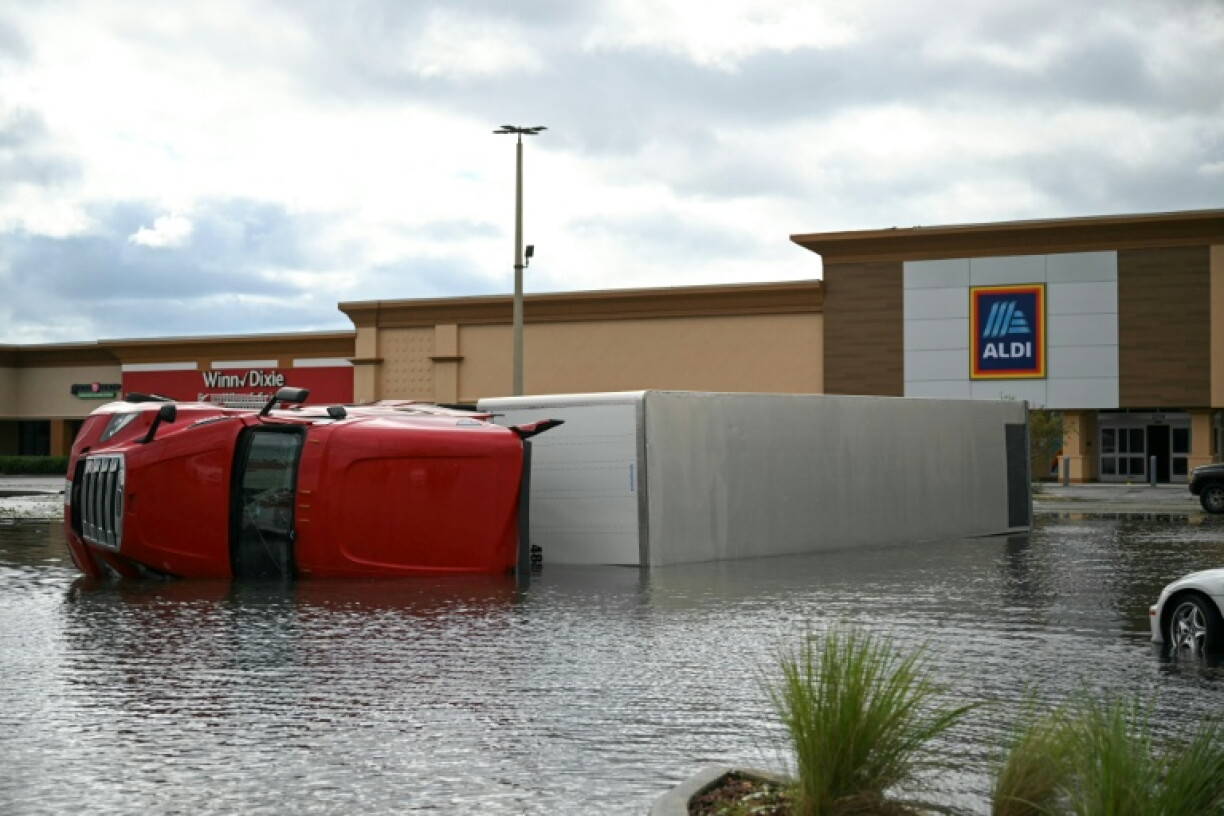The strong wind overturned a truck in a grocery store parking lot