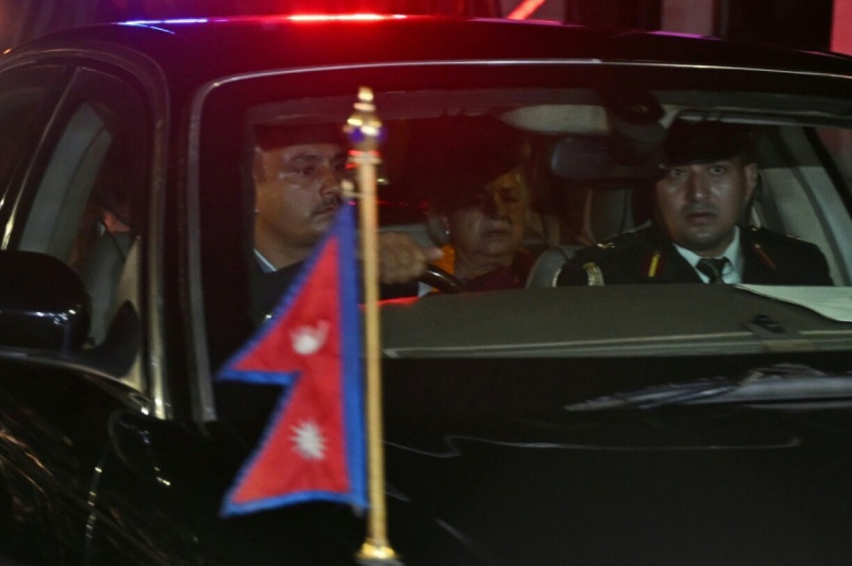 Nepal's new Prime Minister Sushila Karki (C) leaves the presidential palace after her swearing-in-ceremony in Kathmandu