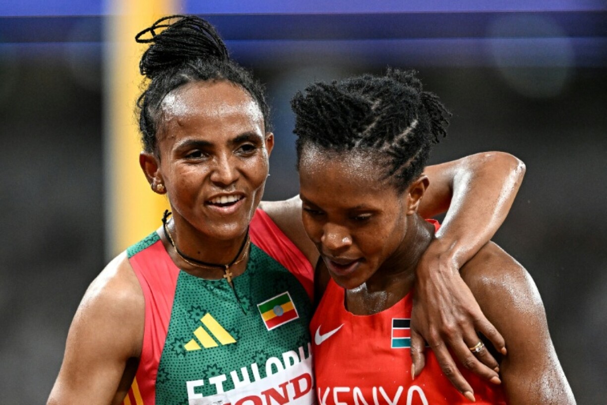 Ethiopia's Gudaf Tsegay (L) and Kenya's Faith Kipyegon react after competing in the women's 5000m heats