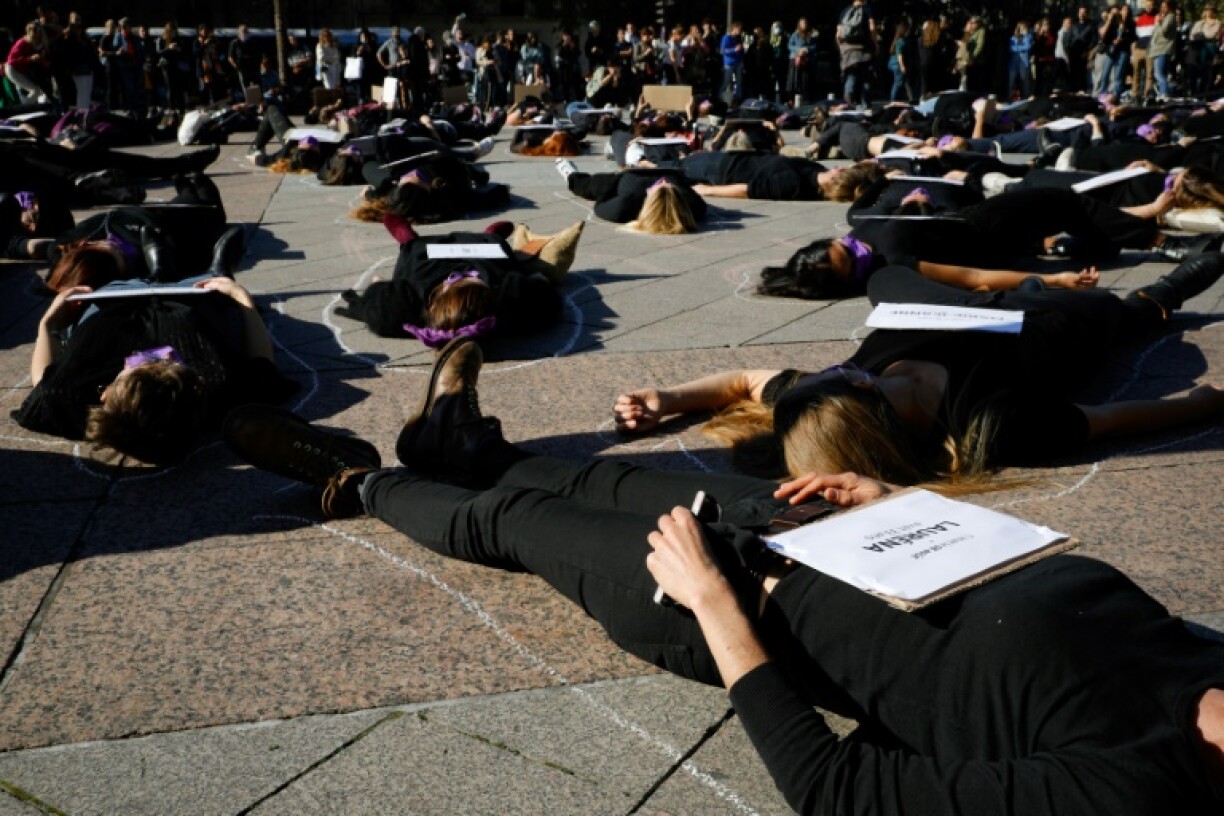 Women stage a protest against femicide in front of Paris city hall in 2021