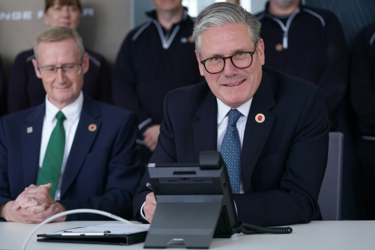 Britain's Prime Minister Keir Starmer smiles as he discusses a UK-US trade deal with US President Donald Trump over the phone at a car factory in the West Midlands, May 8, 2025.