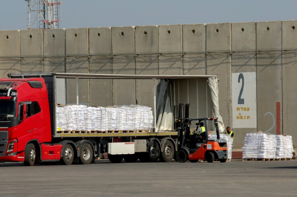 A worker loads humanitarian aid on a truck at the Kerem Shalom crossing between southern Israel and the Gaza Strip, on May 22, 2025