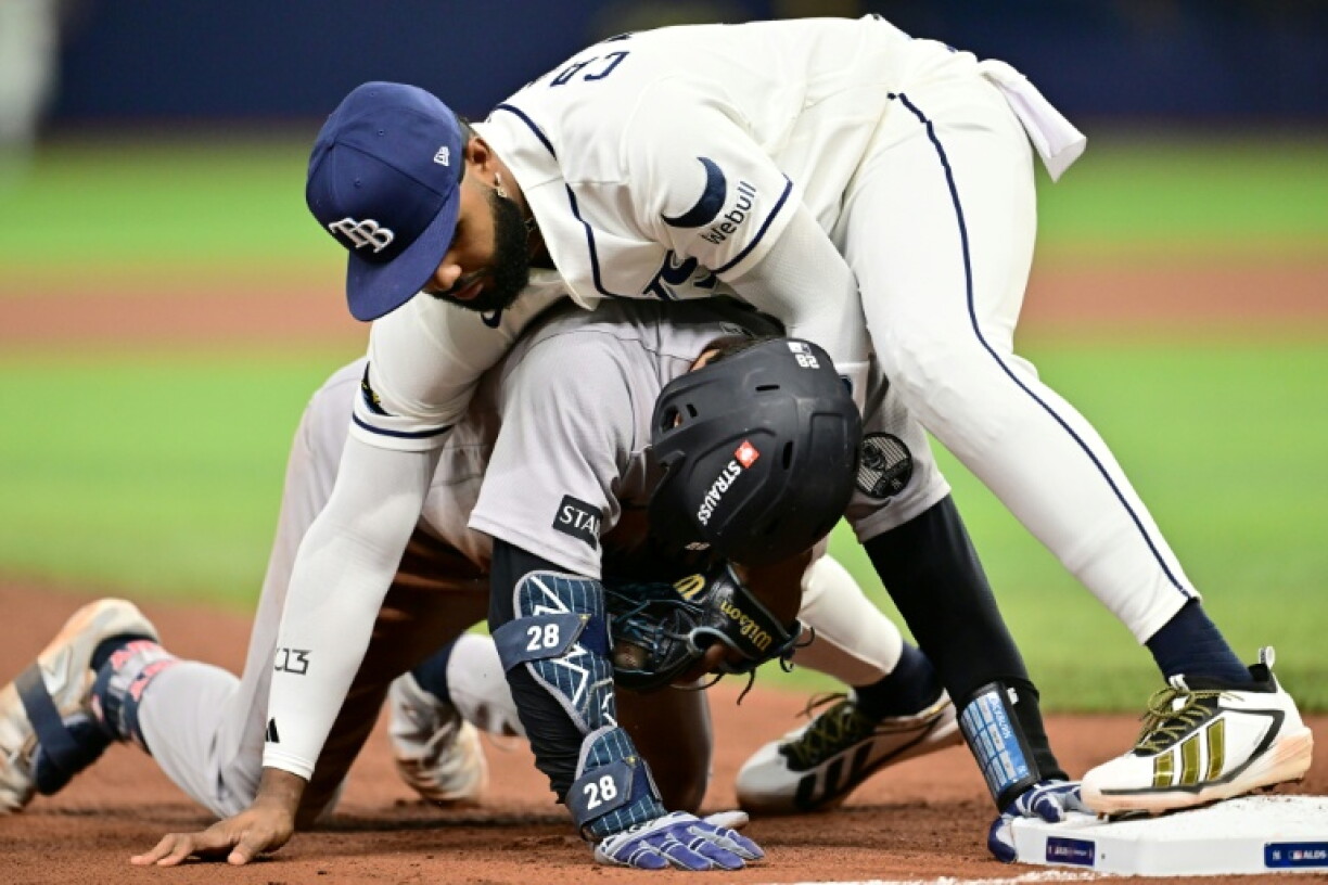 Junior Caminero of the Tampa Bay Rays tags out New York's Austin Wells at third base in the Rays' MLB playoff win over the Yankees