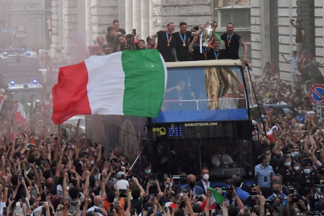 Les joueurs italiens fêtent leur titre européen avec la foule lors d'une parade sur un bus à impériale, le 12 juillet 2021 à Rome
